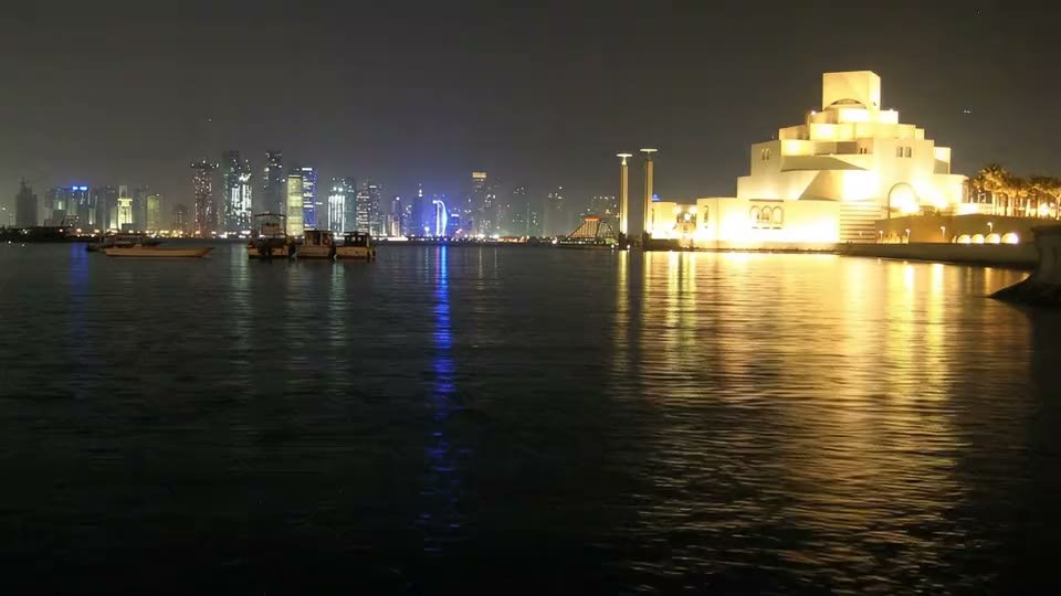 Museum of Islamic Art glowing across the bay in Doha at night